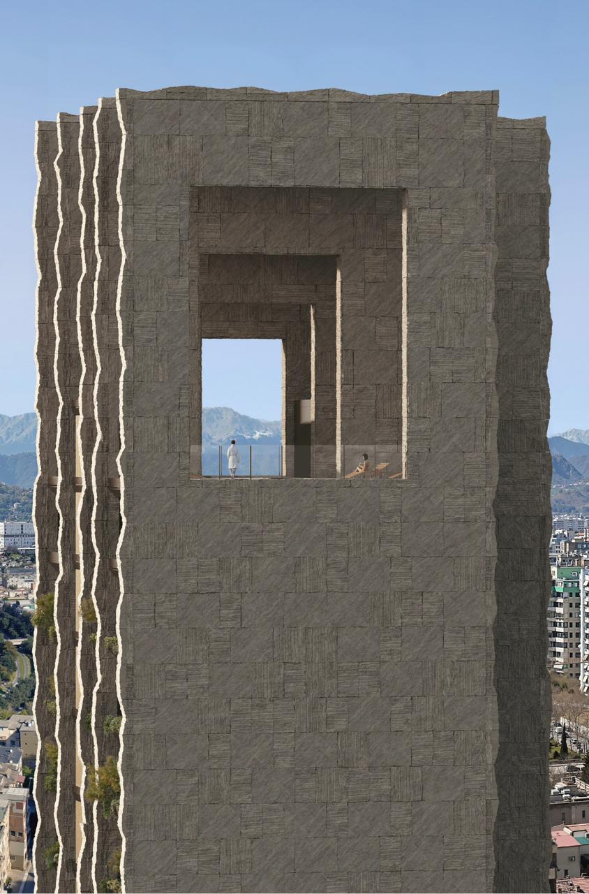 Guri Tower crown with iconic opening framing mountains